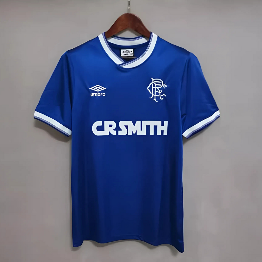 Blue Rangers Home sports jersey made by umbro from 1984/97  on a grey background