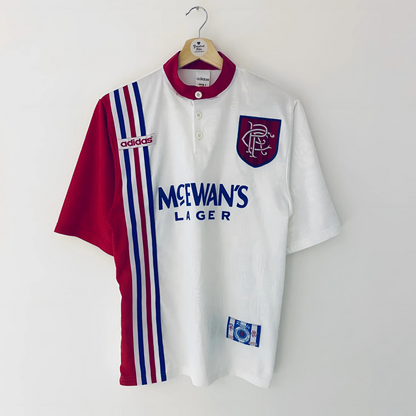 White & Red Rangers football away jersey from 1996/97 with red and blue accents, featuring Adidas logo and McEwan's Lager branding, on a white background.