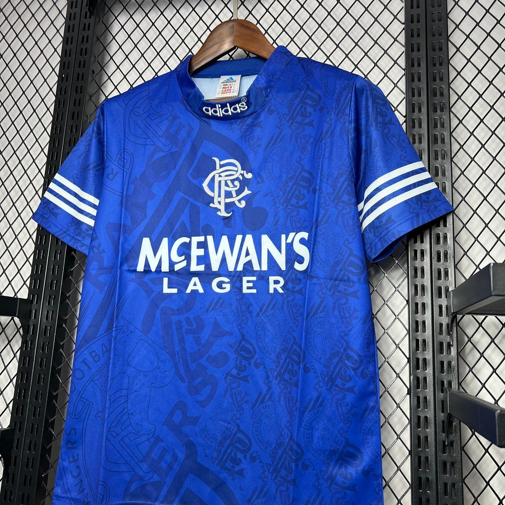 Blue & white Rangers retro home jersey from 1994/96 with Adidas logo and McEwan's Lager branding on a hanger.
