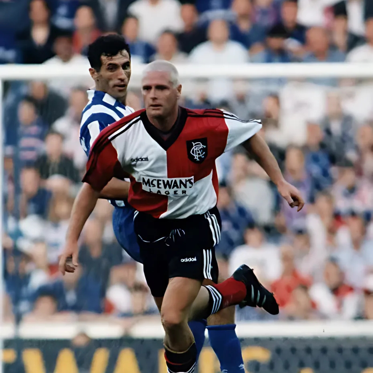 Chequered Red and white Rangers Away football jersey from 1995/96 with Adidas logo and McEwan's Lager branding being worn by Paul Gascoigne during a football match