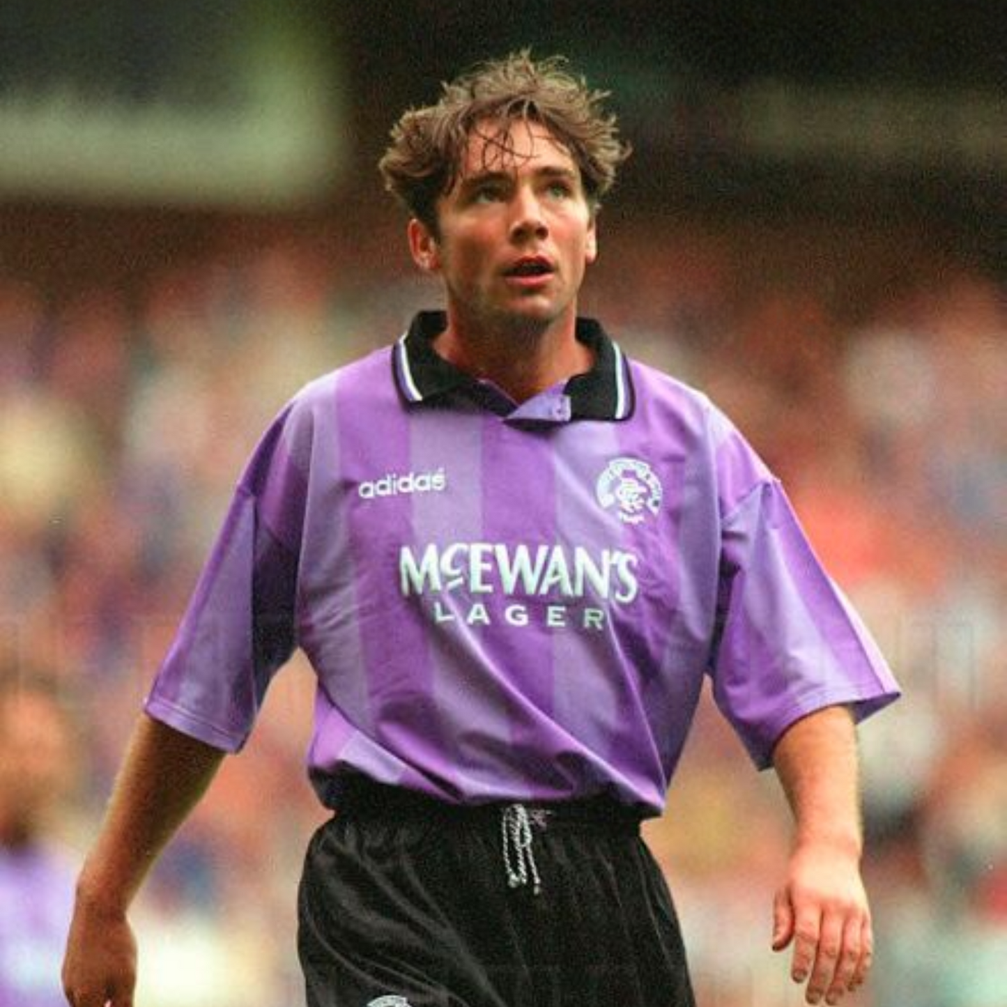 Striped Purple Rangers FC away sports jersey from 1994/95 with Adidas logo and McEwan's Lager text being worn by Ally McCoist during a football match