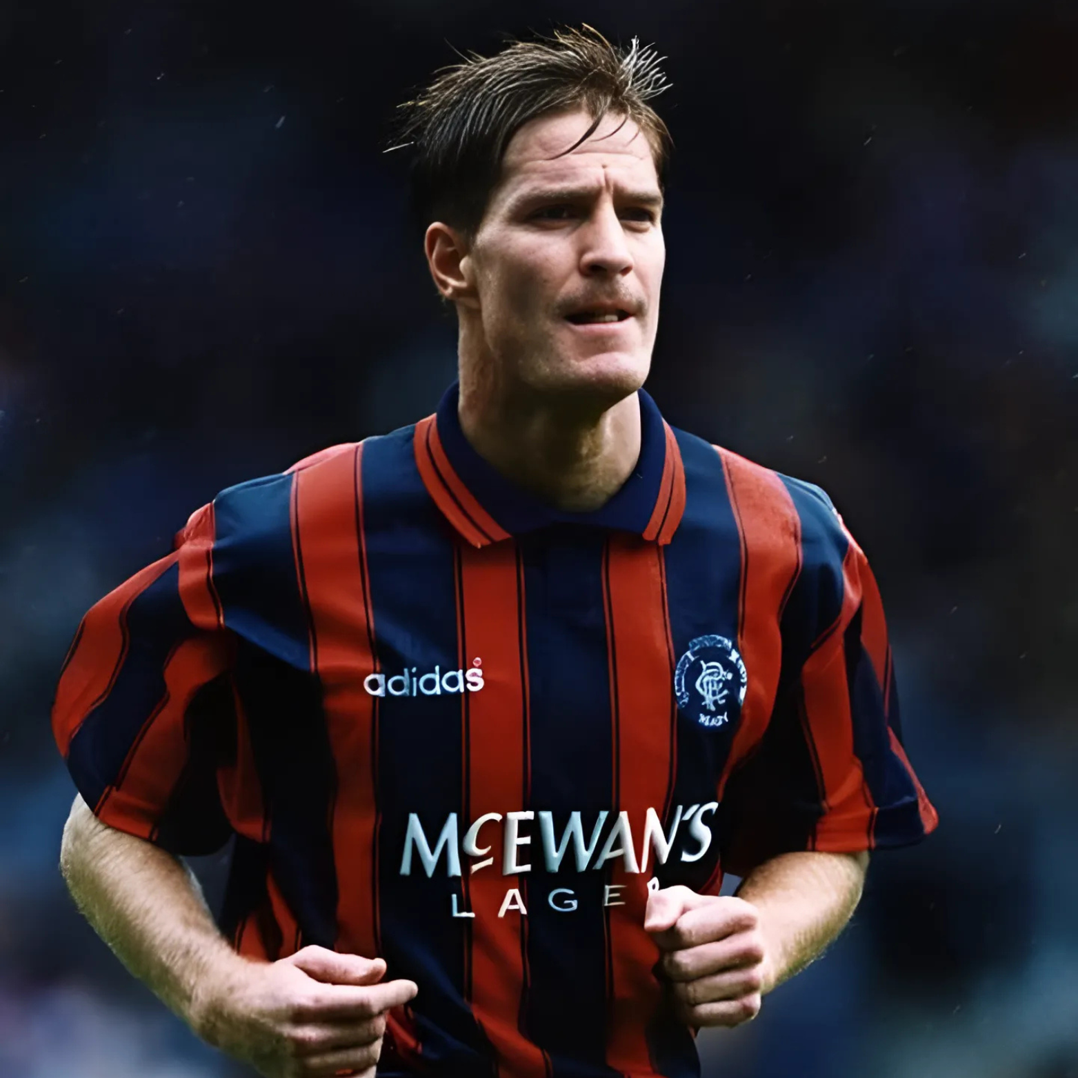 Blue and orange striped Rangers retro vintage sports jersey from 1994/95with Adidas and McEwan's Lager branding being worn by Richard Gough during a football match